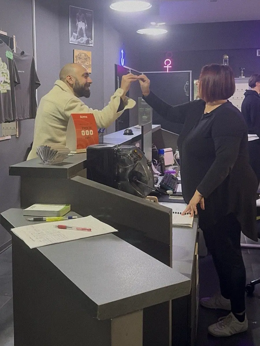 Saluto tra un socio e lo staff alla reception di MedusA Gym